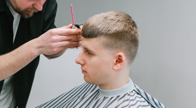 mężczyzna podczas strzyżenia u fryzjera